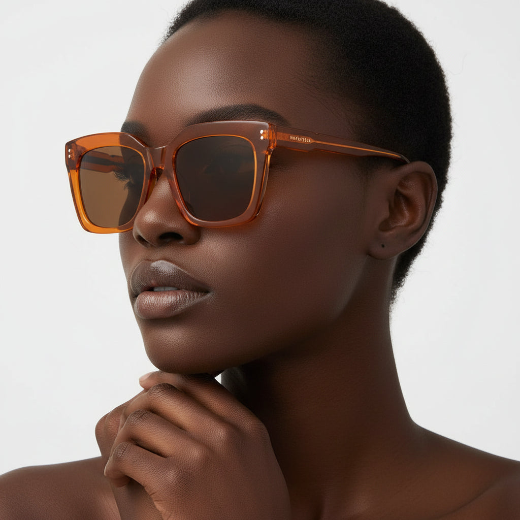 Orange sunglasses with brown lenses on a white background